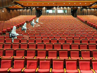Workers in China disinfect a cinema as they prepare to reopen.