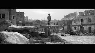 The unsettling 60 second spot Keep Their Voices Alive is set in Syria, a desolate war-torn landscape of burnt out cars and twisted iron poking out of fallen concrete.