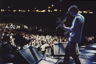 Oasis Knebworth 1996 is the story of the special relationship between Oasis and their fans that made the largest concert of the ‘90’s possible. It is told entirely in the moment through the eyes of the fans who were there, built around extensive, and never-before seen archive concert and backstage footage from the event, with additional interviews with the band and concert organizers. Photo by Roberta Parkin.