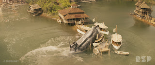 As the river boat nears the port town, a submarine arrives on the scene and fires a torpedo in its direction. The boat narrowly escapes, but the torpedo continues racing through the water until it explodes into the town, destroying it.