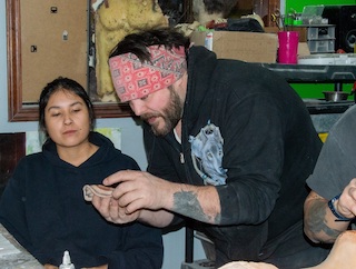 Native American artist and Tulsa business owner Tate Steinsiek teaches a special effects technique to student Kylie Dirtseller during the Introduction to FX Gore and Blood Gags for Film course, which was sponsored by the Cherokee Nation Film Office.