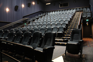 Stadium seating really started to take off during what some people have called the AMC Era. It began in 1995 with the AMC Grand 24 Theatre in Dallas.